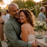 Couple embracing at vow renewal weekend celebration outdoors.