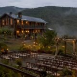 Mountain wedding lodge at dusk with ceremony setup