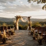 Rustic mountain wedding arch at sunset