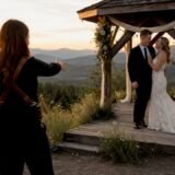 Bride and groom posing at mountain during golden hour