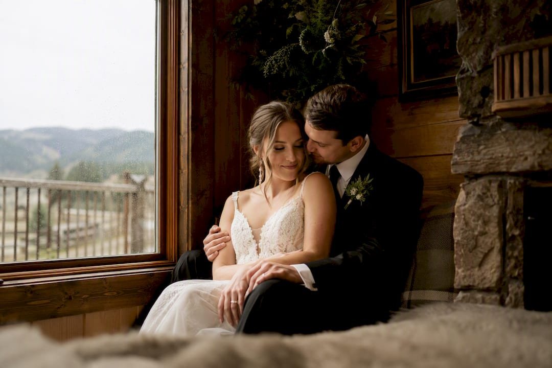 Couple lit by warm window light indoors on overcast day