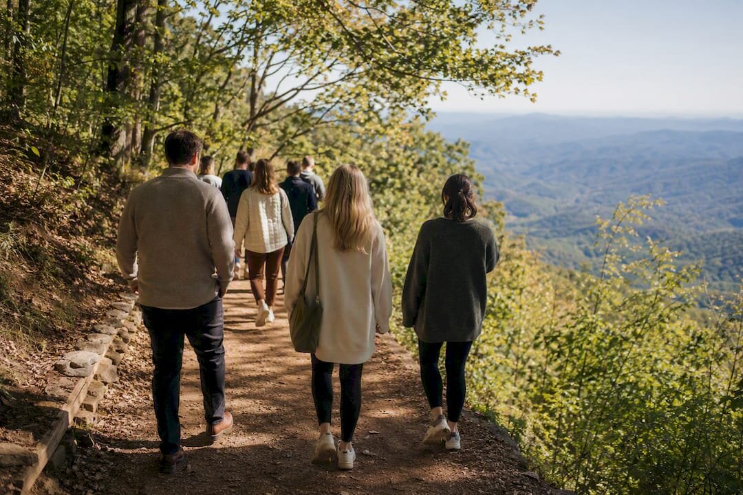 Wedding guests hiking a mountain trail