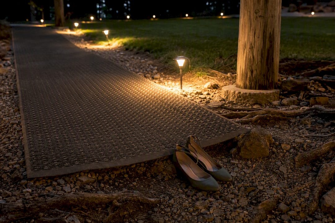Lit matting path across uneven mountain terrain