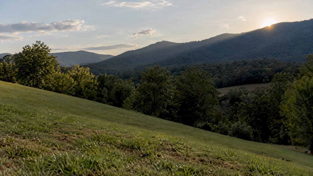Mountain ridge casts shade across venue hillside